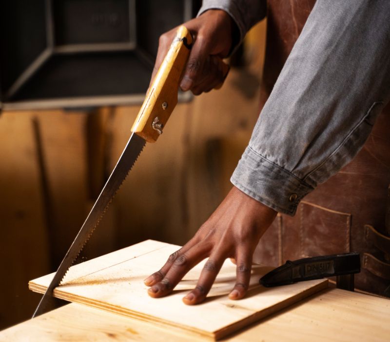 carpenter cutting wood for cabinet making